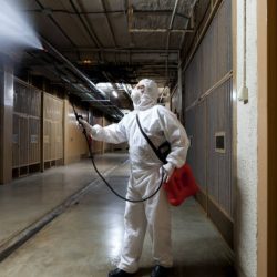 Worker disinfecting the garage of a neighborhood community due to the COVID-19 pandemic